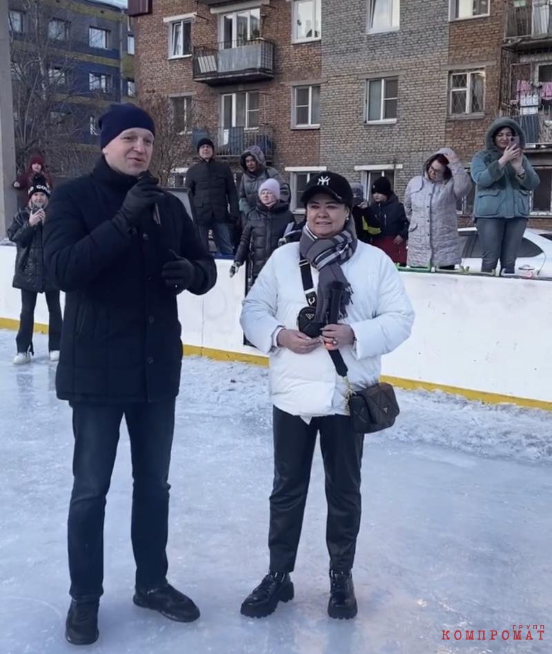 Vitaly Matviychuk and Olga Nosenko.  The latter has a Prada bag slung over her shoulder.